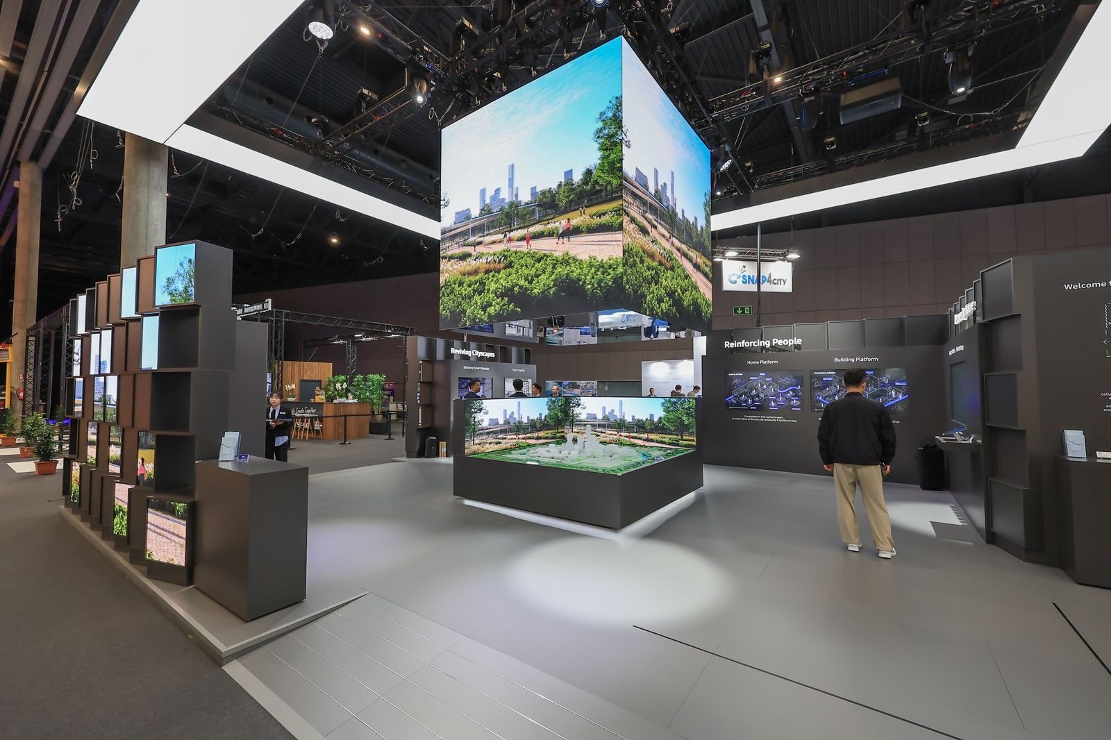Visitors look around Samsung C&T's exhibition booth at the 2023 Smart City Expo World Congress.