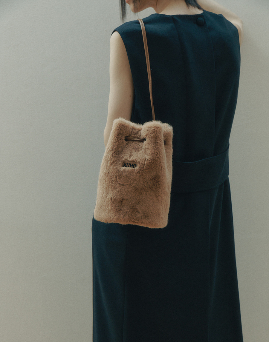 The eco-fur bucket bag by KUHO is so furry that people will want to pet it.
