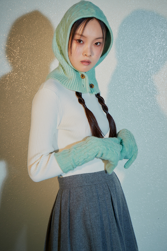 A button-up knitted balaclava by kuho plus looks minty fresh while keeping you warm above the shoulders.