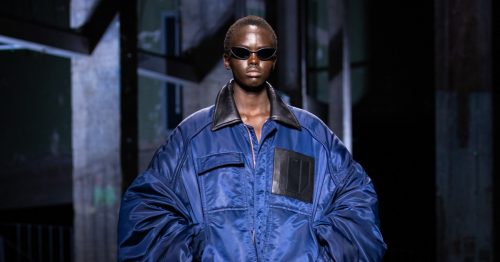 Model walks the runway in blue Juun.J workwear jacket at Paris Fashion Week
