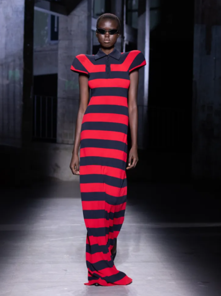 Model walks the runway in Juun.J red and navy striped maxi length dress with accentuated shoulders at Paris Fashion Week