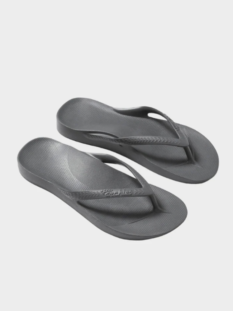 A pair of grey flip flops with extra arch support by the brand Archies