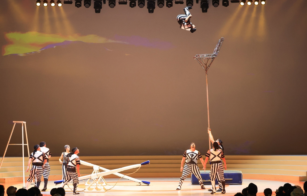 Circus performers perform gravity-defying acrobatics on stage at a theme park in South Korea.