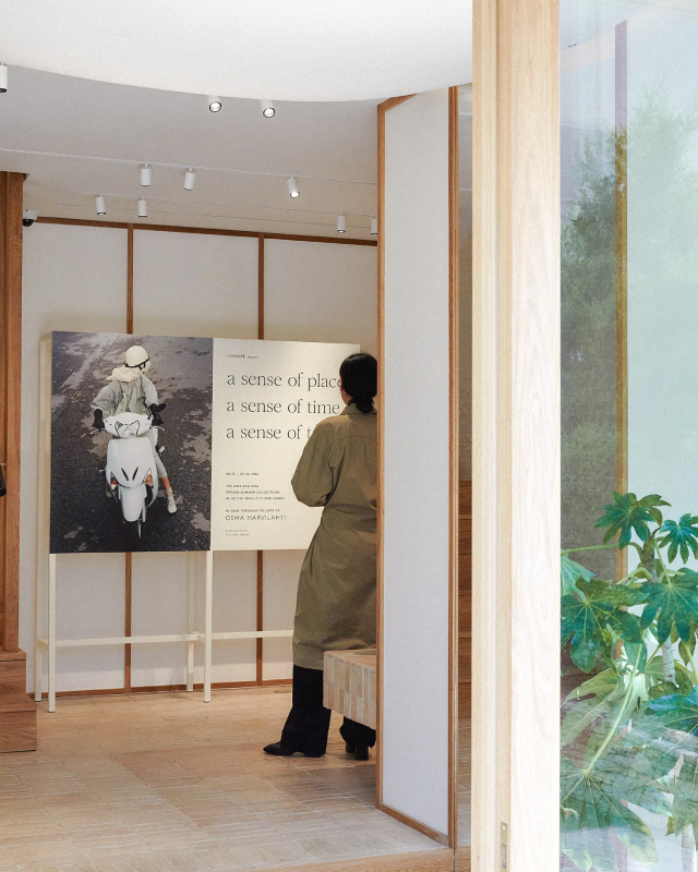 A woman reads from a panel in an art gallery during an art exhibition at LEMAIRE’s flagship store in Seoul.