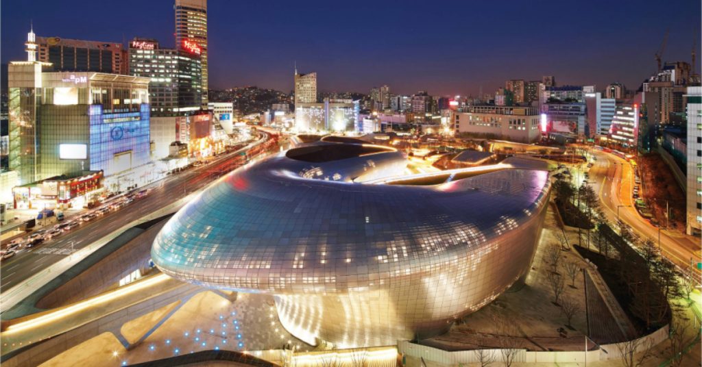 Dongdaemun Design Plaza lit up at night, with its smooth, flowing curves and modern design creating an impressive urban landscape.