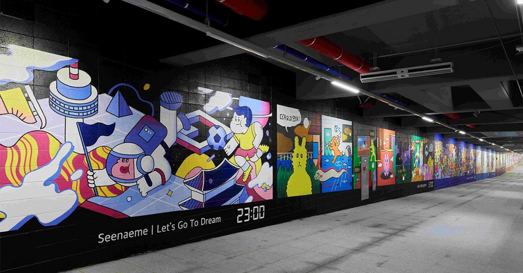 A vibrant mural featuring an astronaut holding a flag, a soccer player, and various abstract shapes and futuristic buildings, titled 'Let's Go To Dream' with a time display of 23:00 in the bottom right.