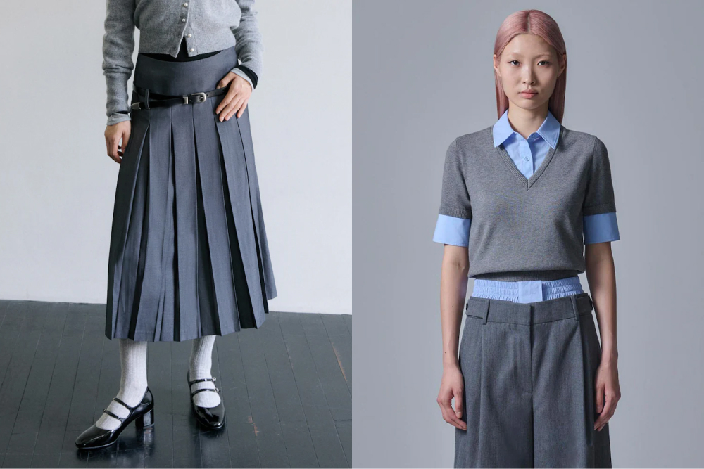 On the left, a model wears a Maïs charcoal grey wool pleated skirt paired with mary jane shoes and white socks, creating a classic uniform-inspired look. On the right, another model sports a Juun.J grey short-sleeved V-neck pullover over a blue collared shirt, with matching tailored trousers, embracing a minimalist, clean-cut aesthetic.