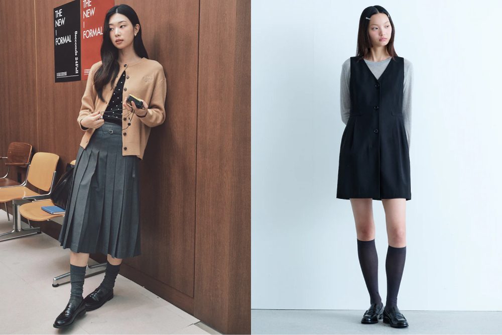 A side-by-side image of two female models. On the left, the model wears a preppy fall outfit from 8 Seconds, featuring a beige cardigan over a black polka-dot blouse, paired with a pleated grey midi skirt, grey knee-high socks, and black loafers. She stands casually by a wooden wall, holding a phone. On the right, the model stands against a plain white background, wearing a black sleeveless dress layered over a grey long-sleeved top, styled with grey knee-high socks and black loafers from Kuho Plus.