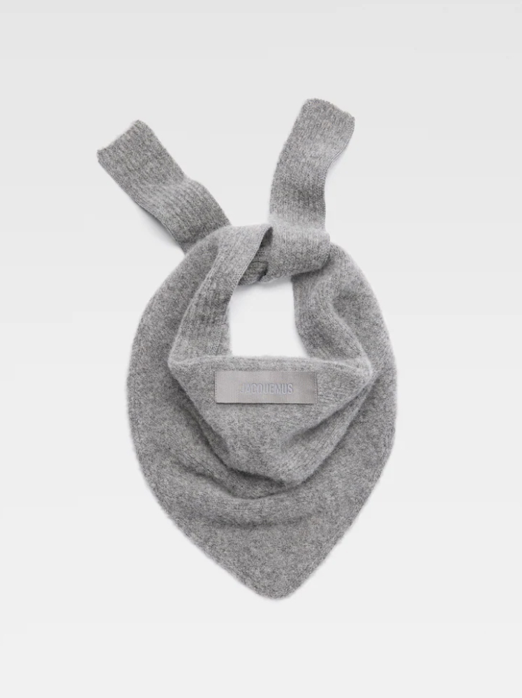 A grey shawl-style scarf tied up with an alpaca wool texture