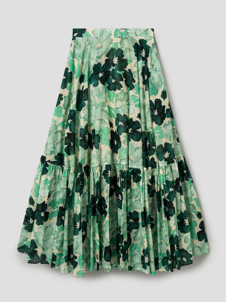 A voluminous midi skirt with large green flowers printed on it over a mint background made by the label Plan C.