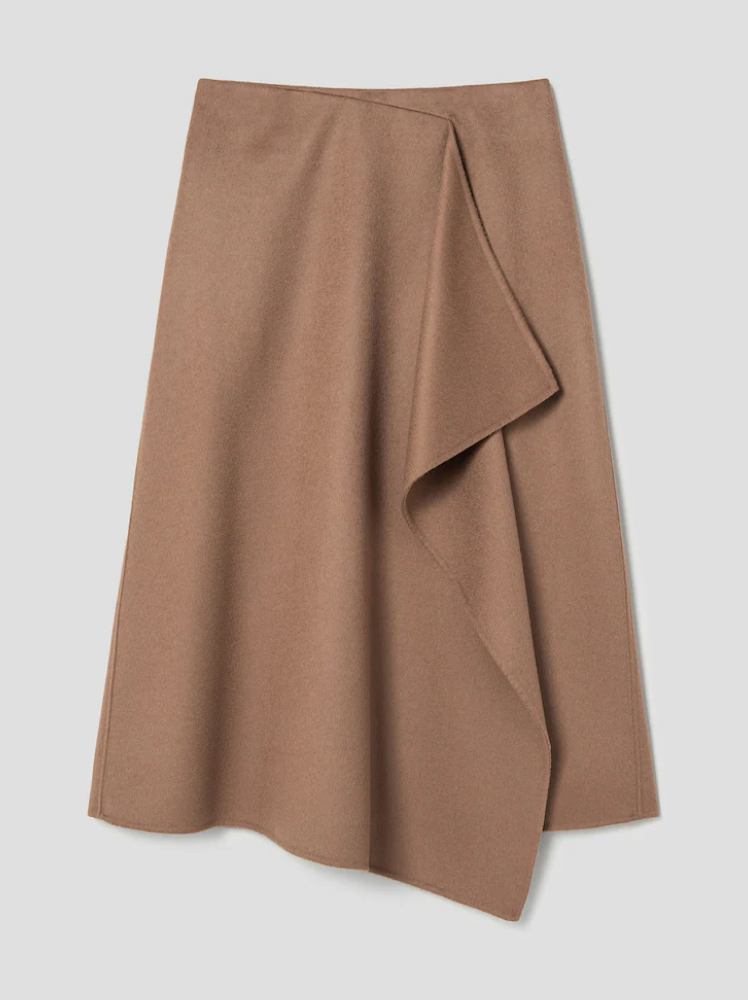 A simple A-line skirt with a draped detail down the middle made from a soft wool material in a camel color; skirt made by the South Korean brand Juun.J.