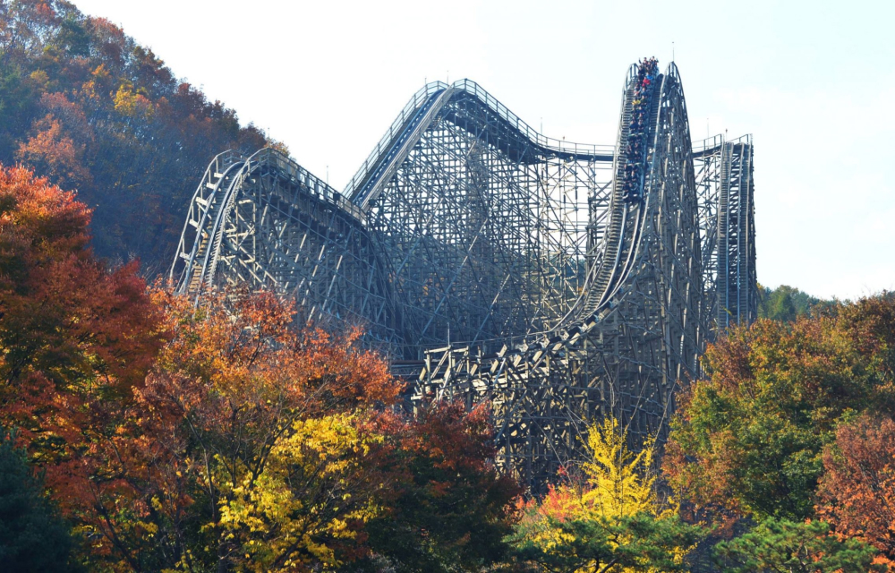 Hidden behind fall foliage and autumnal trees, Everland Resort’s ‘T Express’ roller coaster, the world’s tallest roller coaster, can be seen standing at a peak height of 56m, with a carriage full of thrill-seeking visitors flying down the structure at rapid speeds with their arms in the air.