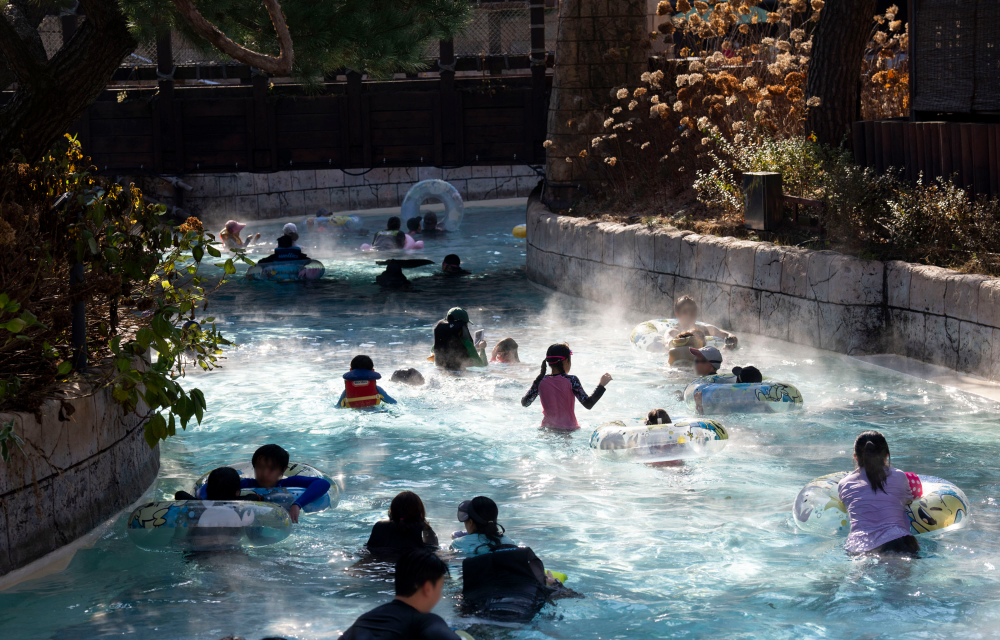 Guests at Caribbean Bay float along the park’s lazy river that extends from the outdoors into an indoor spa cave and is heated for the winter season. Some guests float along with inflatable tube rings while some opt to float with a simple life jacket or not floating device at all. The warmth of the pool can be seen from the hot steam hitting the cold winter air.