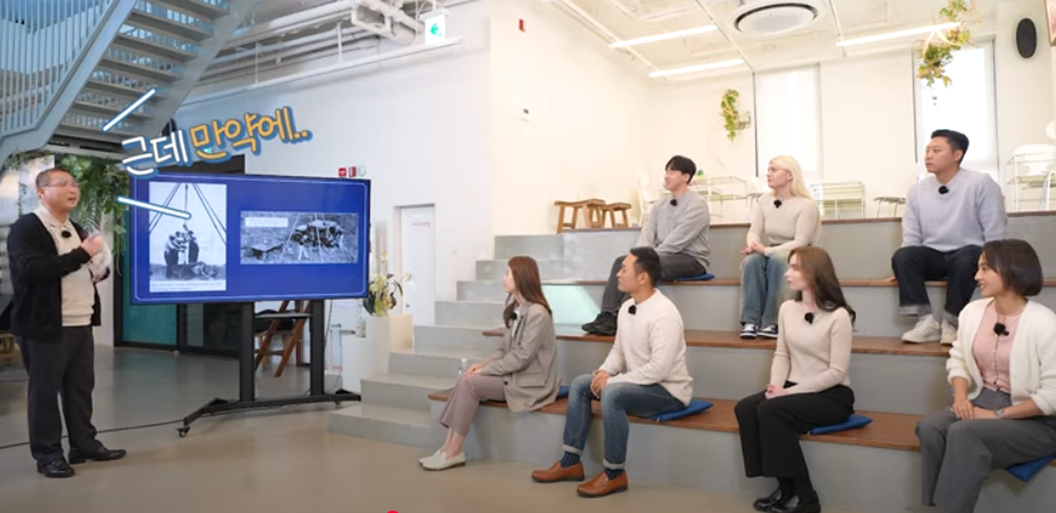 Park Wan-seo engages with a seated audience in a contemporary lecture space, discussing geotechnical engineering and historical architecture.