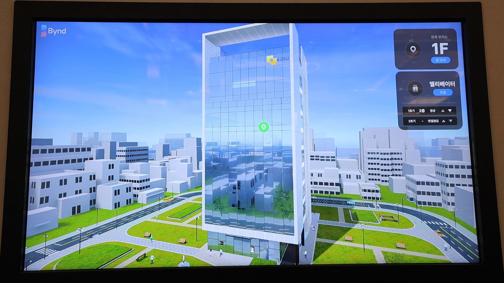 A screen displaying a 3D digital twin of an office building on the Bynd platform interface, showing real-time elevator status and building navigation by Samsung C&T E&C Group.