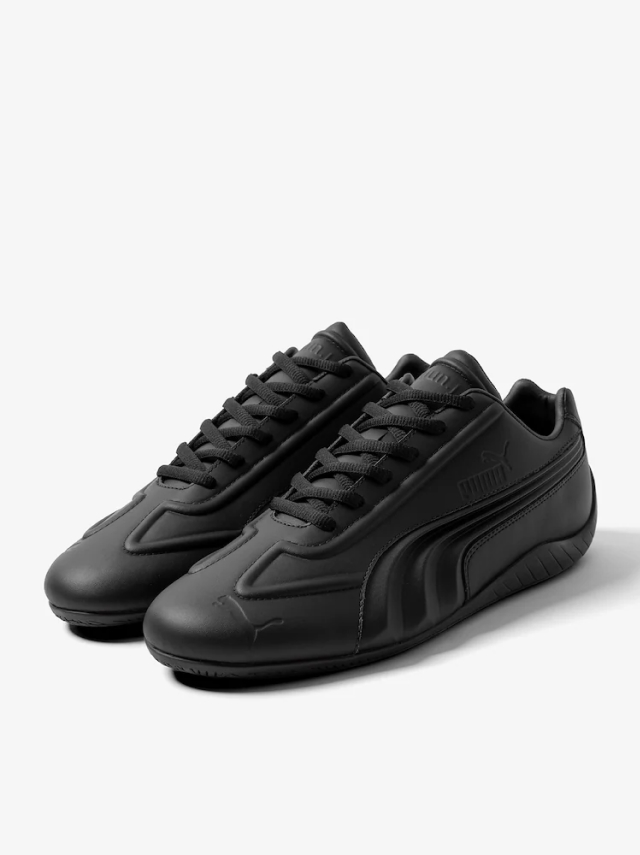Matte black sneakers with a low profile and black laces by the Korean luxury fashion brand Juun.J in a collaboration with PUMA.