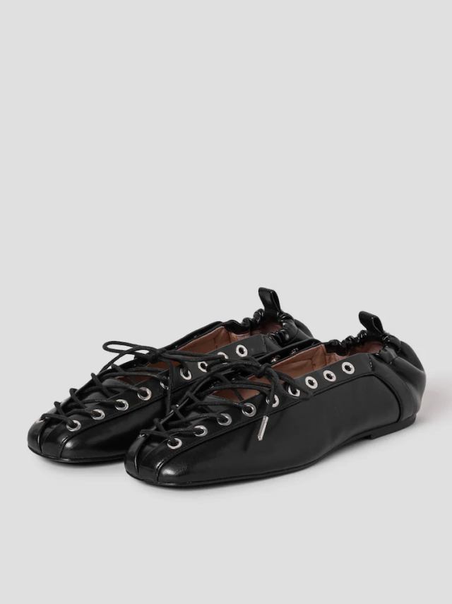 GANNI black ballet-style lace-ups with gathered elastic back and silver eyelets.