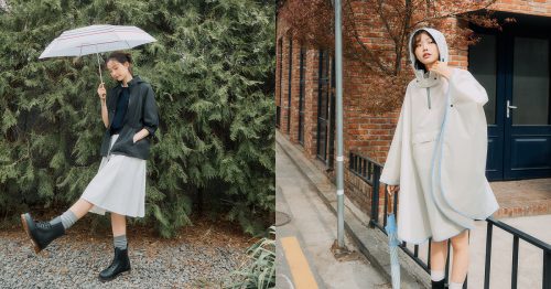 Left Image: A woman holds a white umbrella with red stripes while wearing a black rain jacket, light gray skirt, gray socks, and black lace-up rain boots, standing playfully in front of a green pine tree backdrop. Right Image: A woman wearing a white hooded rain poncho with light blue trim stands on a sidewalk beside a red brick building, holding a folded blue umbrella in one hand and adjusting her hood with the other.
