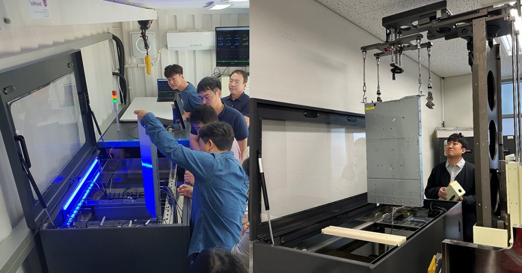 Engineers working with immersion cooling tanks and equipment inside a testing facility, examining hardware submerged in dielectric fluid.