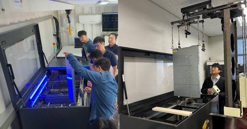 Engineers working with immersion cooling tanks and equipment inside a testing facility, examining hardware submerged in dielectric fluid.