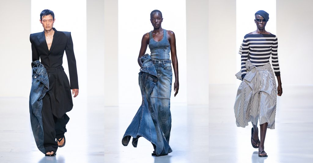 From left to right, models showcase key looks from Juun.J’s 26SS collection. The first wears a sharp tailored black blazer and voluminous trousers with raw denim accents. The second presents a structured denim dress paired with deconstructed denim detailing. The third wears a striped off-shoulder top and voluminous striped skirt, styled with a beret and sunglasses for a modern nautical twist.