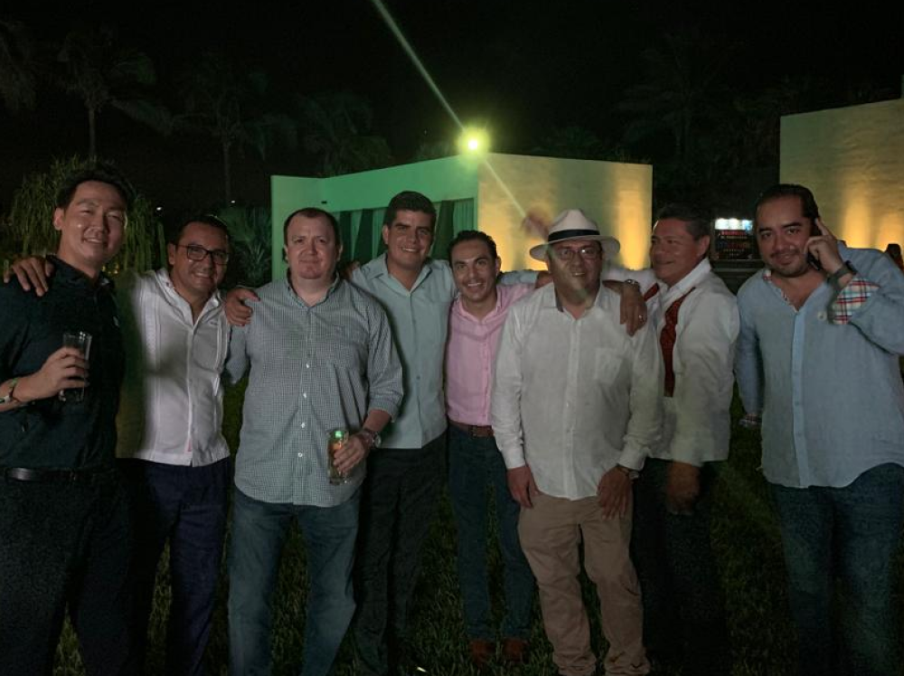 Work colleagues gather together at night for a group photo
