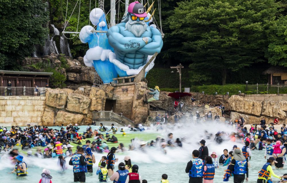 Guests at Korea’s Caribbean Bay water park enjoy wave pool fun while wearing life jackets as part of the summer ’Mega Wave’ festival.