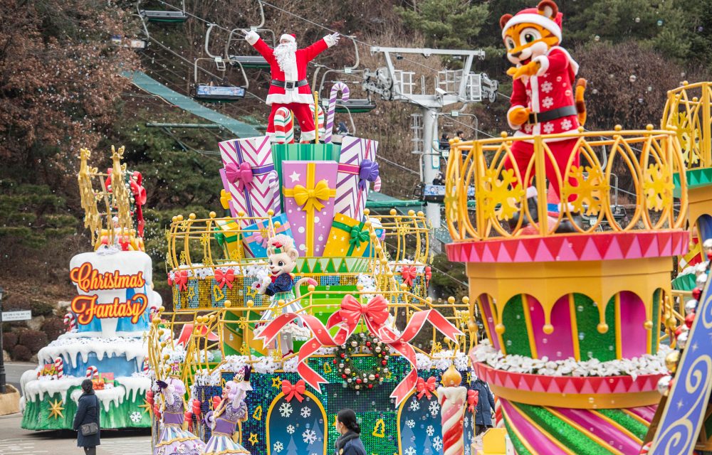 Santa on a colorful parade float – Santa Claus and characters wave from festive floats during a Christmas parade at Everland Resort