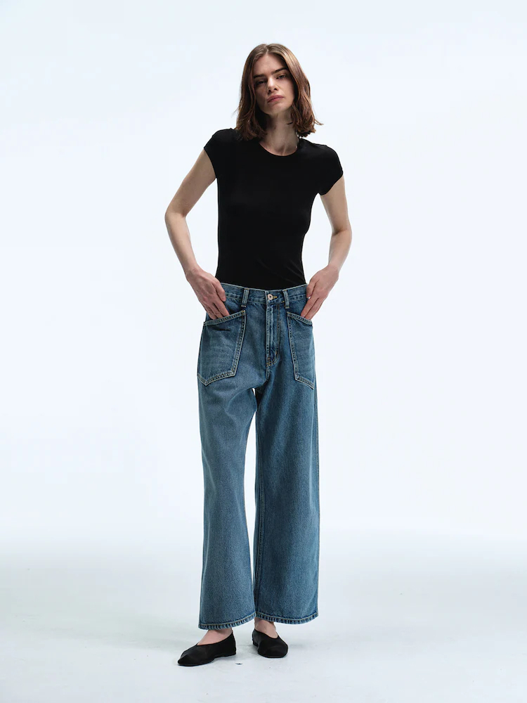 Model wears the Women Straight Fit Denim Pants in Sky Blue, styled with a fitted black tee for a clean and confident everyday look.
