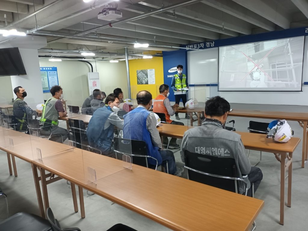 Site workers participate in a focused safety briefing on equipment and procedures