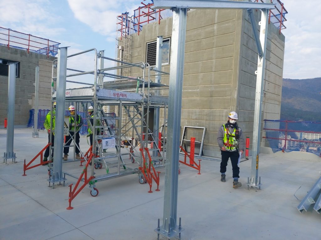 Safety team members hold a worksite meeting to review plans and coordinate tasks