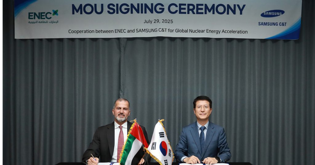 Mohamed Al Hammadi, CEO of ENEC (left), and Oh Se-chul, CEO of Samsung C&T E&C Group (right), seated at a table during the MOU signing ceremony on July 29, 2025, with the UAE and South Korean flags displayed between them.