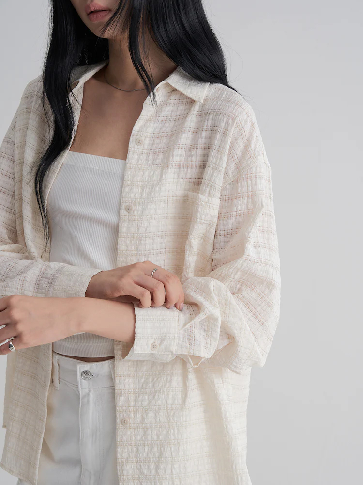 Female model wearing the 8seconds Ivory Overfit Check Shirt, styled open over a white ribbed tank and white denim. The shirt is crafted from a rayon-blend with a relaxed fit, offering breathable comfort for everyday wear.