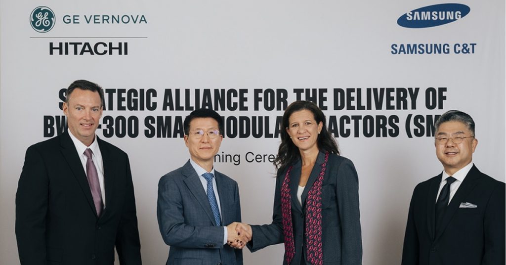 Executives from Samsung C&T and GE Vernova Hitachi Nuclear Energy stand together at the signing ceremony, with Samsung C&T President Oh Se-chul and GE Vernova Power CEO Mavi Zingoni shaking hands at the center.