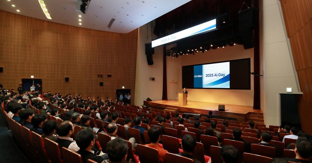 Wide view of the audience seated in the auditorium during the 2025 AI Day opening session.