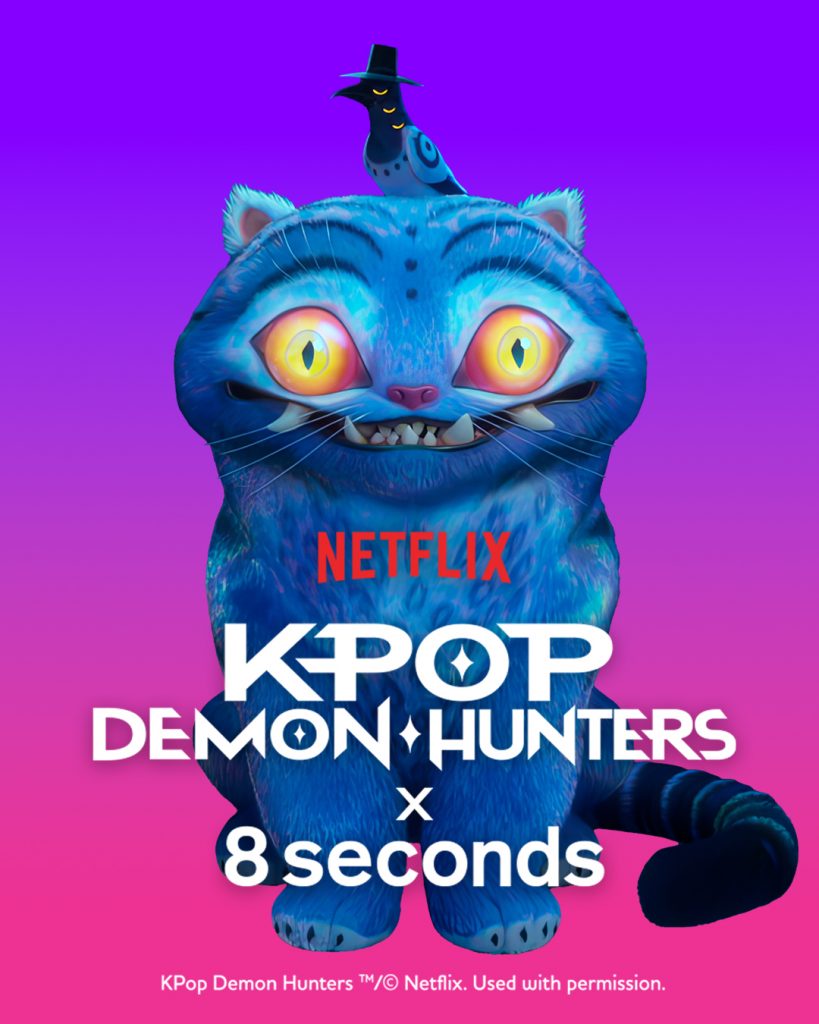 Promotional image featuring “Duffy,” a large blue tiger character from K-Pop Demon Hunters, with a small black hat-wearing creature on its head. The Netflix, K-Pop Demon Hunters, and 8seconds logos appear below on a purple gradient background.