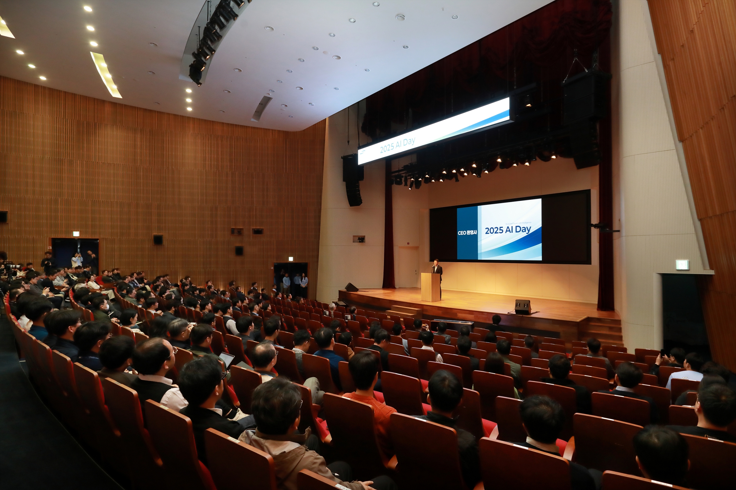 Wide view of the audience seated in the auditorium during the 2025 AI Day opening session.