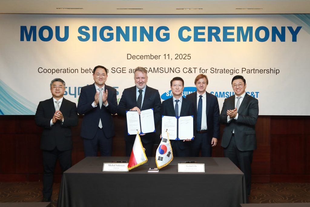 Executives from Samsung C&T and Synthos Green Energy hold signed documents during an MoU signing ceremony in Seoul on December 11, 2025.