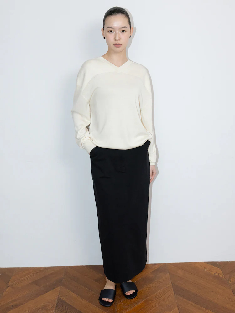 The Aperture Spring Mac sweater in ivory featuring a clean V-neck silhouette and detachable shoulder detail