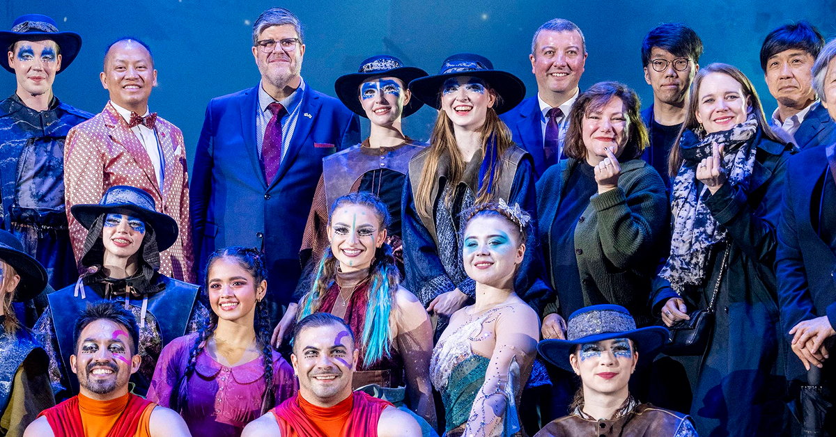 Canadian Ambassador to Korea and Québec Government representatives stand with Cirque Éloize performers in costume on stage after the Wings of Memory circus performance at Everland