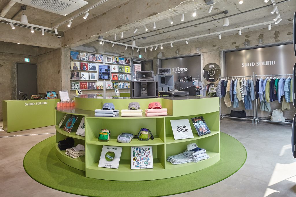Interior of SAND SOUND 26SS pop-up store in Seongsu with record displays, clothing racks, and music-inspired layout