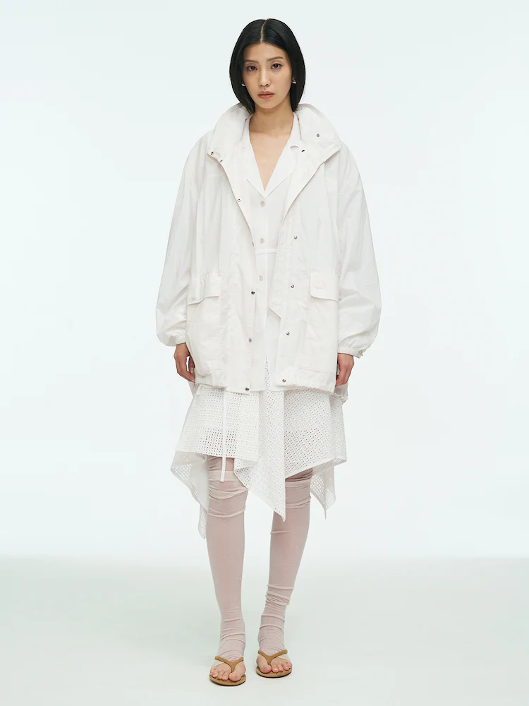 'anggae' Light Nylon Coat in white offers an airy, oversized layer for effortless spring styling and transitional weather