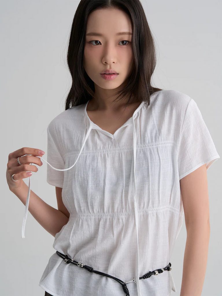 Model wearing 8seconds ALL-DAY CREASE Shirred Short-Sleeve Blouse in white with brown pants.