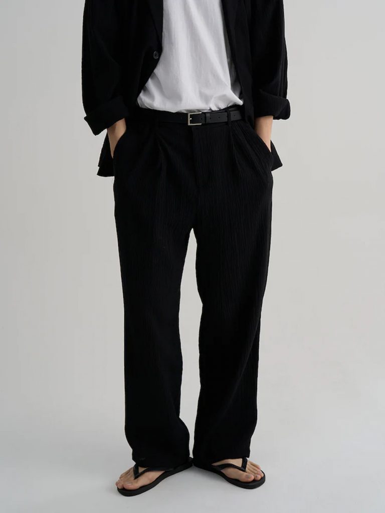 Model wearing 8seconds ALL-DAY CREASE Wide-Fit Set-Up Pants in black with a matching short-sleeve shirt.