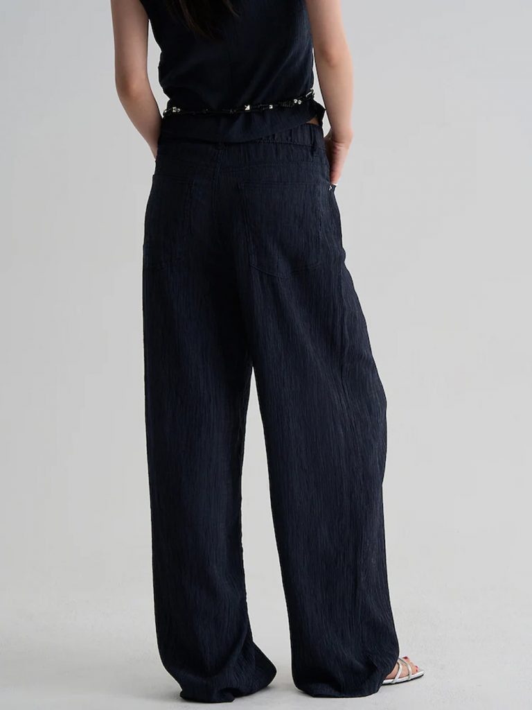 Model wearing 8seconds ALL-DAY CREASE Wide Pants in navy with a matching textured top.