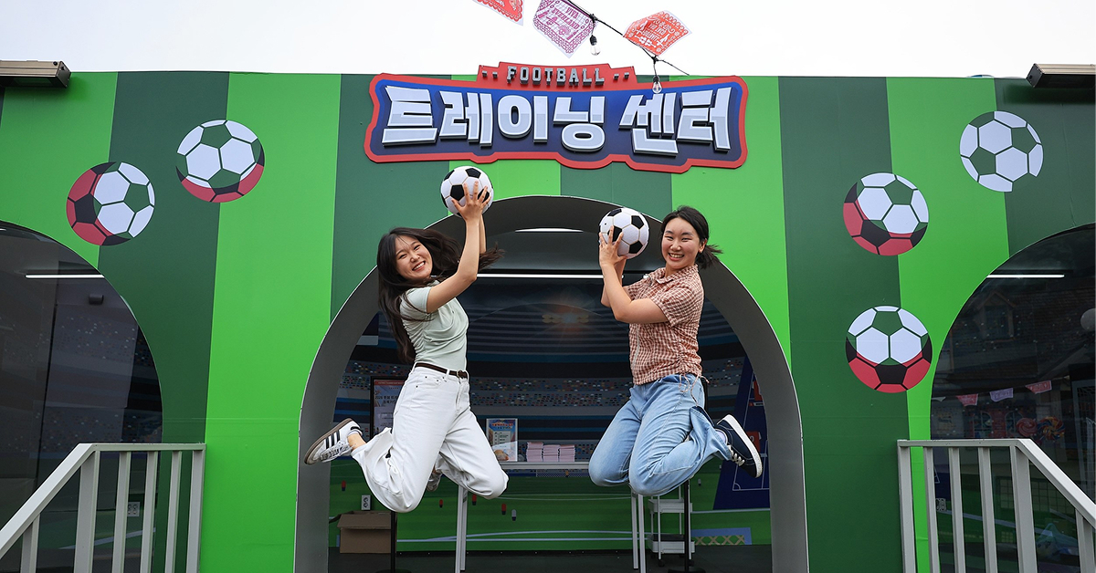 Visitors pose with footballs at Everland’s Football Training Camp, part of the June Whatever Series theme “Football & Taco.”