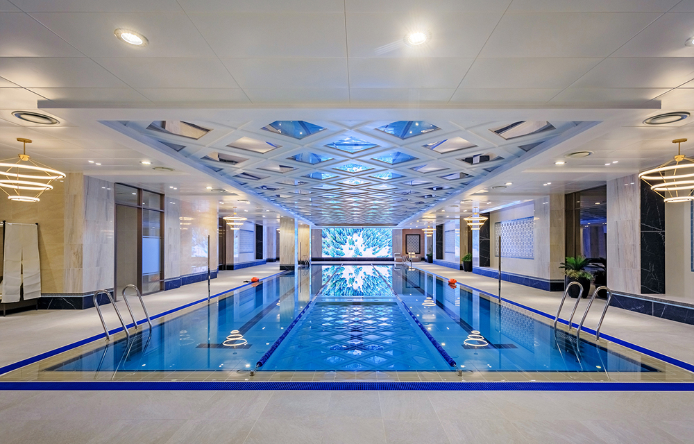 The swimming pool at Raemian One Perla combines premium materials, reflective surfaces, and refined lighting to create an elevated community experience