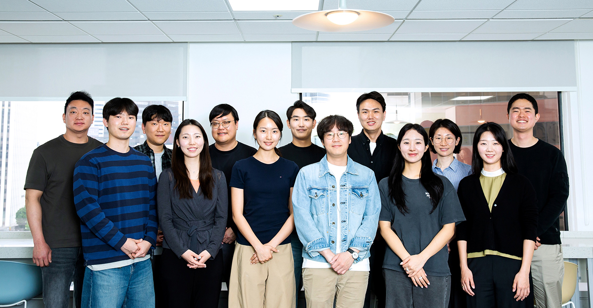 Members of Development 1 Group stand together indoors for a group photo.
