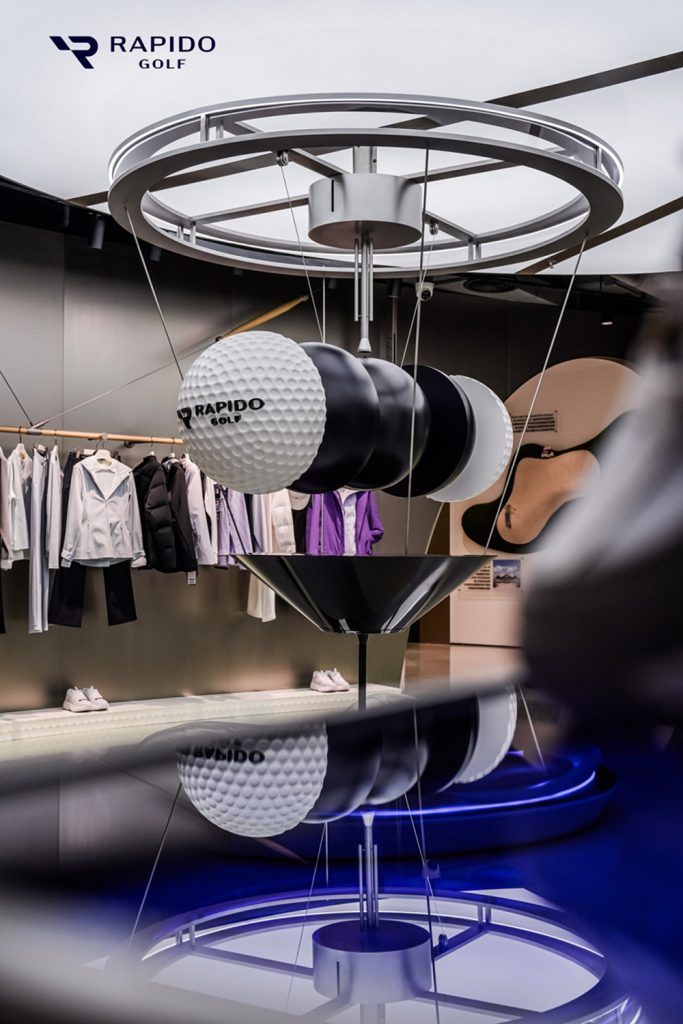 A sculptural display of golf-ball forms creates a focal point inside the RAPIDO GOLF flagship store
